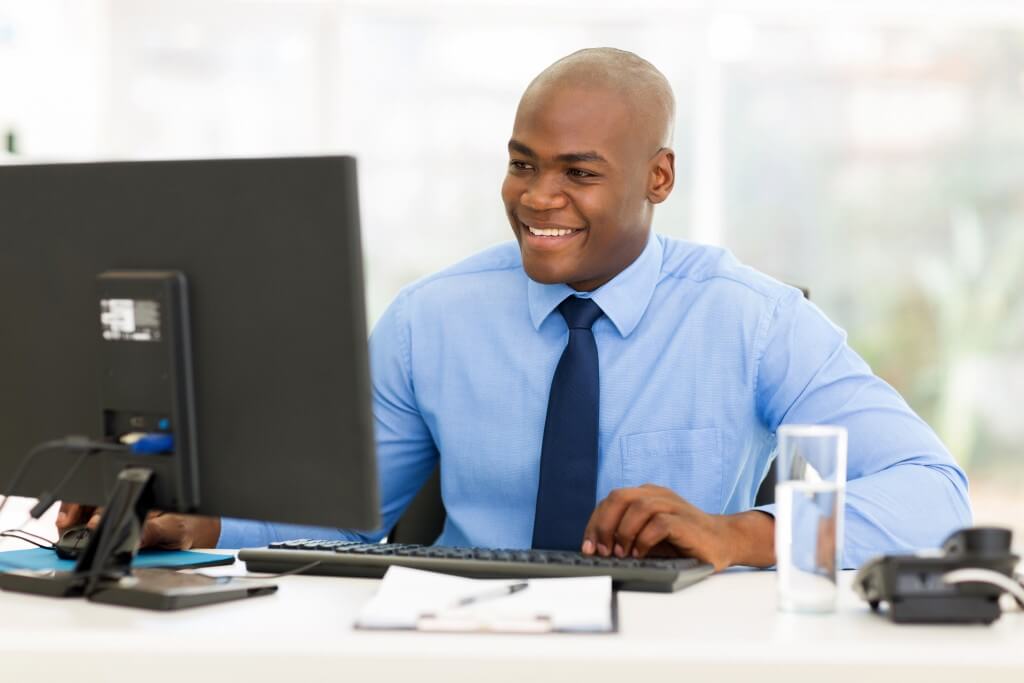 happy afro american business man using computer