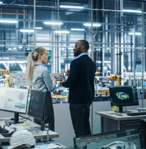 Man and woman in manufacturing facility