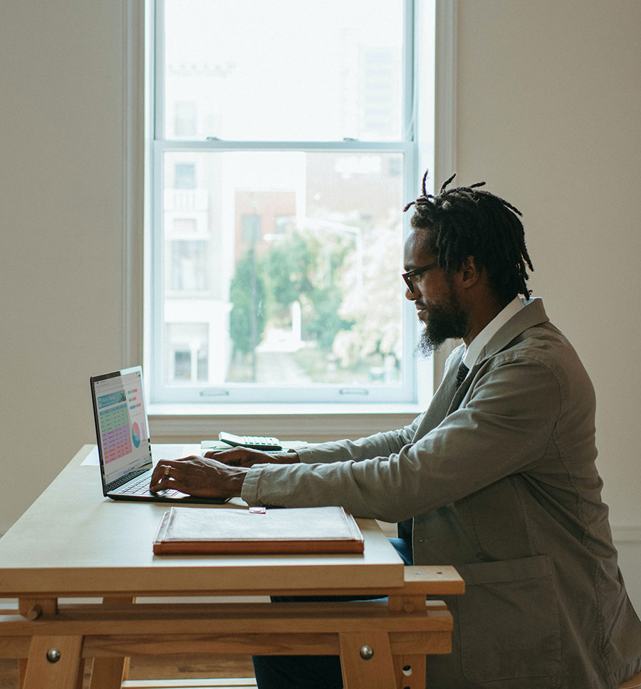 Man working at computer near window